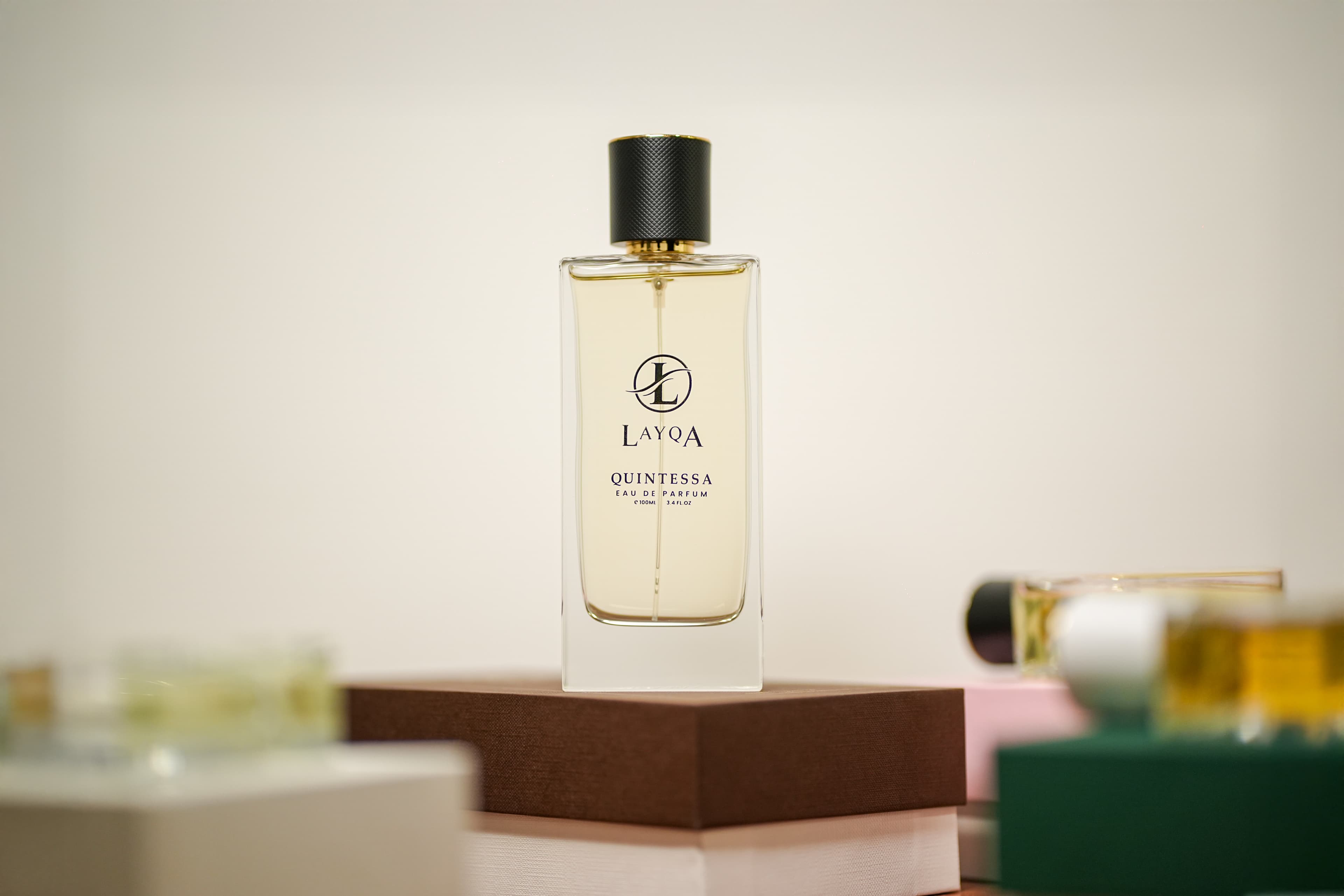 A luxury perfume bottle against a dark, moody background.